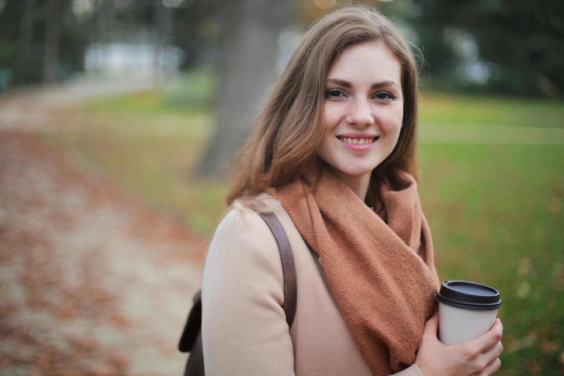 woman holding disposable cup